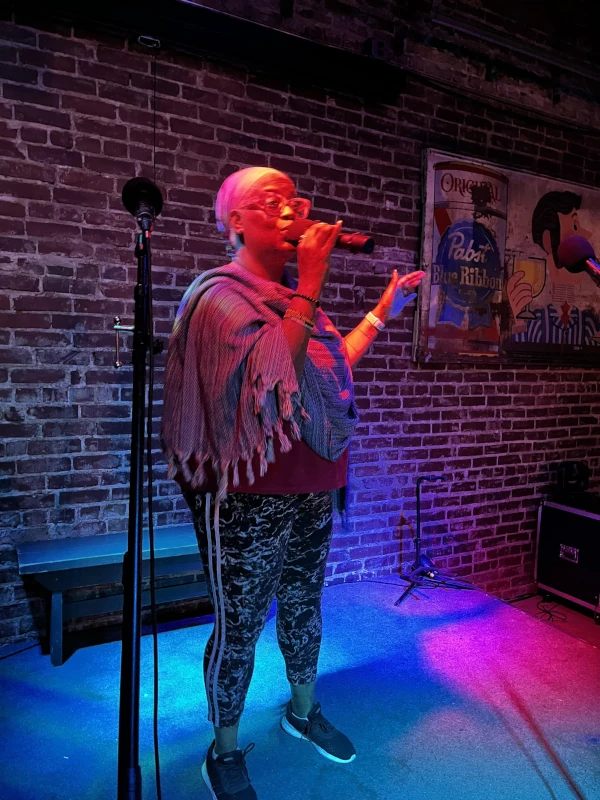 Singer performing on stage at Speakeasy in Carrboro